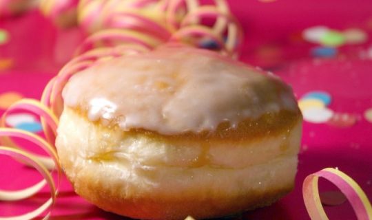 ein Donut mit Luftschlangen und Konfetti