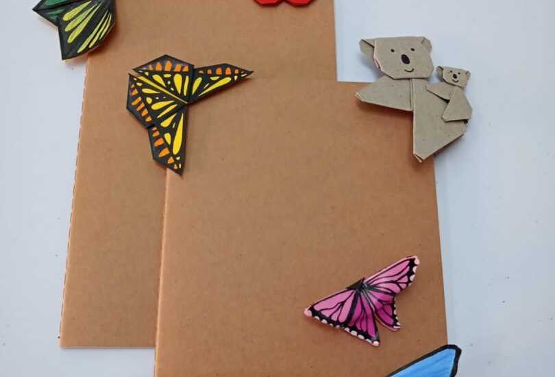 Ein brauner Umschlag mit Papierschmetterlingen und einem BÃ¤ren