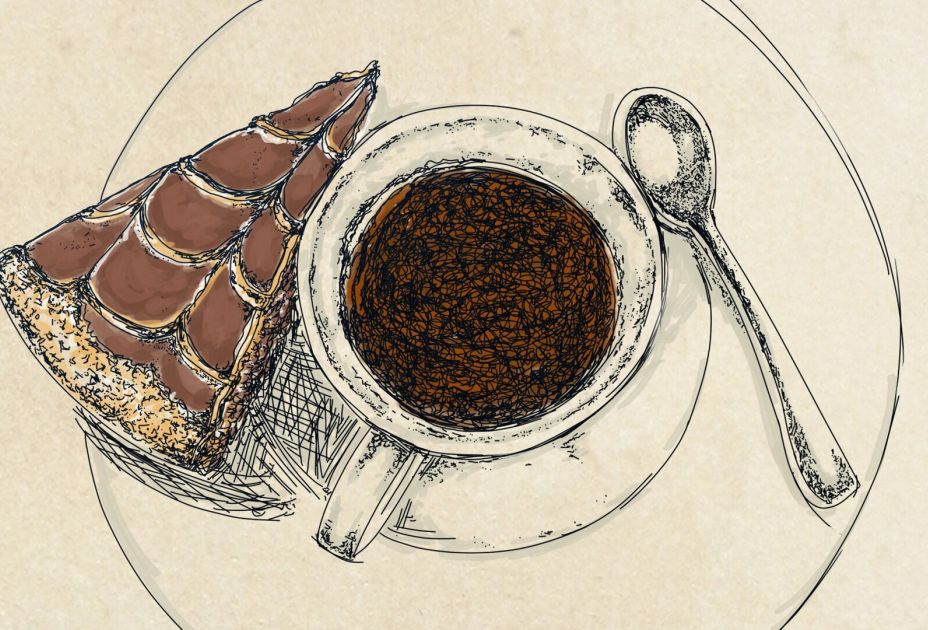 Eine Tasse Kaffee und ein StÃ¼ck Schokolade auf einem Teller
