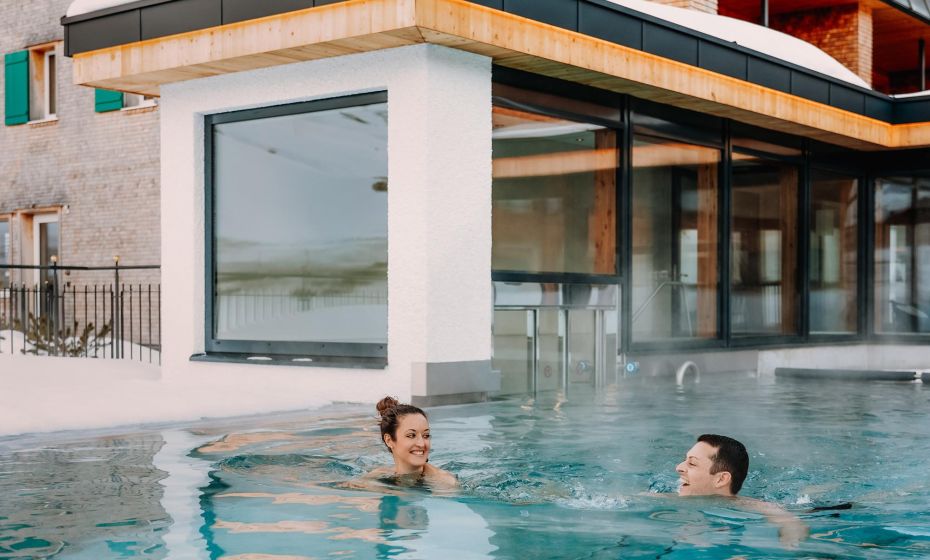 Outdoor pool with massage loungers